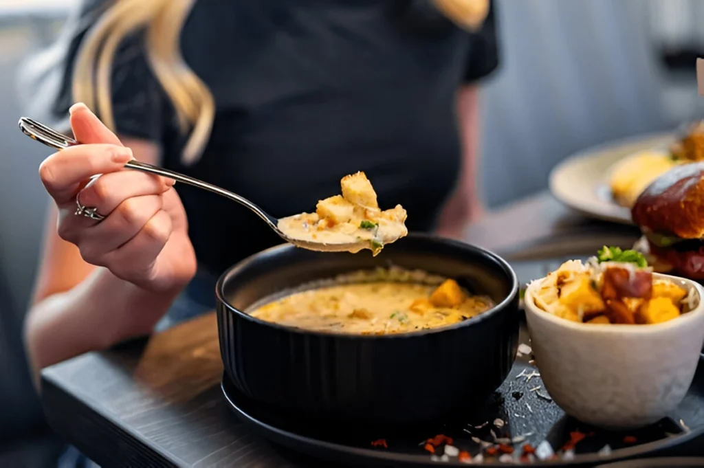 A freshly baked chicken pot pie with a golden, flaky crust, filled with a creamy mixture of chicken, vegetables, and cream of chicken soup, served on a rustic wooden table.