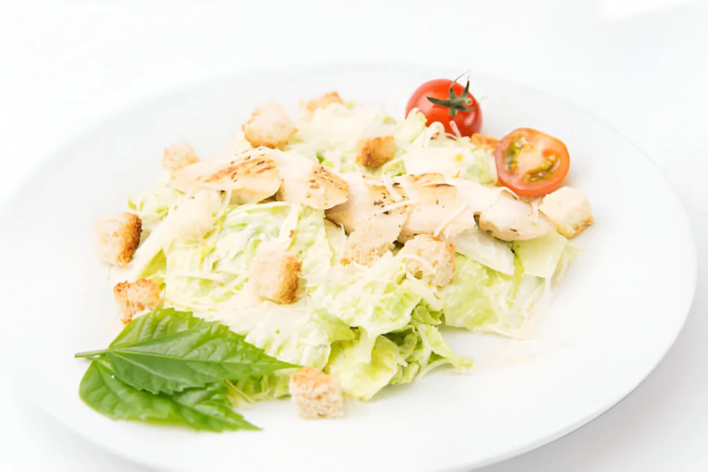 A creamy chicken Alfredo dish served with fettuccine pasta and garnished with fresh parsley, made using jarred Alfredo sauce.