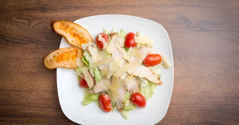 A creamy chicken Alfredo dish served with fettuccine pasta and garnished with fresh parsley, made using jarred Alfredo sauce.