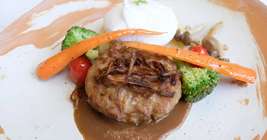 A delicious plate of easy Salisbury steak topped with rich brown gravy, served with mashed potatoes and green beans.