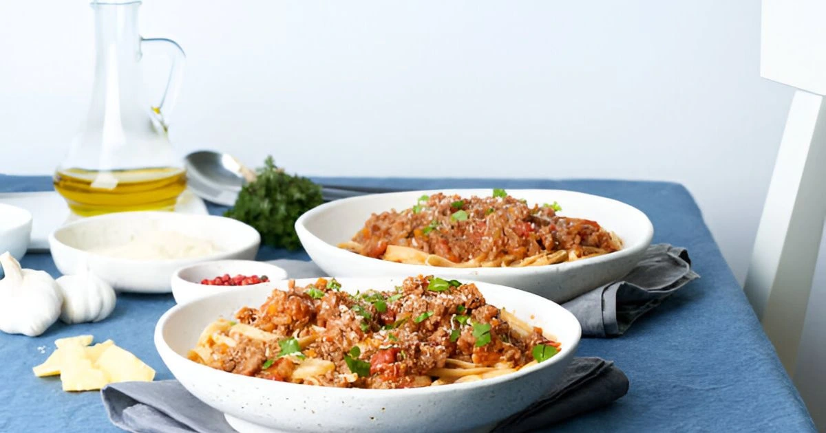 Easy beef stroganoff served in a bowl, garnished with fresh rosemary and paired with buttered noodles, showcasing a slow cooker recipe inspired by Taste of Home.