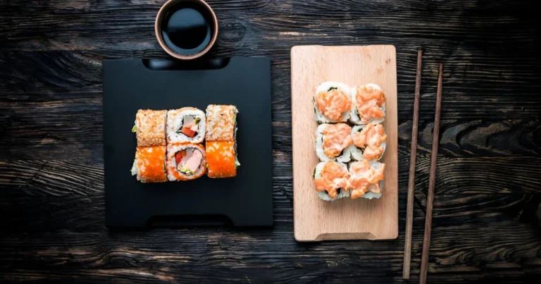 A freshly baked salmon sushi bake served in a casserole dish, garnished with furikake, green onions, and a drizzle of sriracha mayo, ready to be enjoyed with nori sheets.