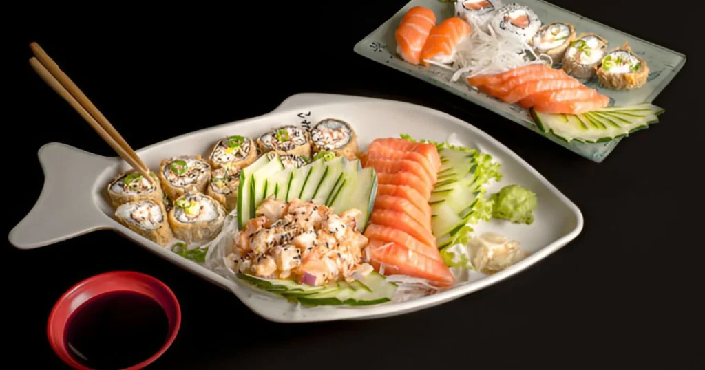 A freshly baked salmon sushi bake served in a casserole dish, garnished with furikake, green onions, and a drizzle of sriracha mayo, ready to be enjoyed with nori sheets.